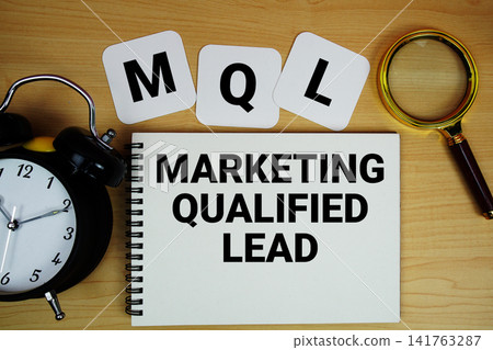 MQL Marketing Qualified Lead text written on notepad with magnifying glass and alarm clock on wooden background MQL Marketing Qualified Lead text written on notepad with magnifying glass and alarm clock on wooden background 141763287