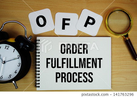 OFP Order Fulfillment Process text written on notepad with magnifying glass and alarm clock on wooden background OFP Order Fulfillment Process text written on notepad with magnifying glass and alarm clock on wooden background 141763296