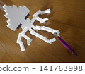 A squid holding a lure placed on the floor. 141763998