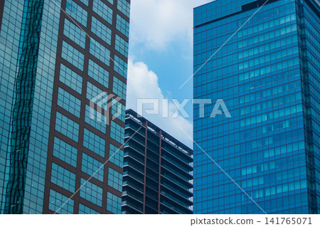 Clouds reflecting off office buildings in the business district 141765071