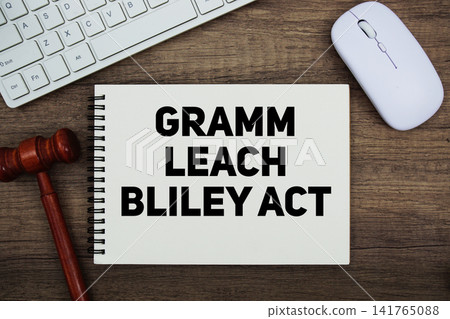 Gramm Leach Bliley Act text written on notepad with gavel and keyboard on wooden background Gramm Leach Bliley Act text written on notepad with gavel and keyboard on wooden background 141765088