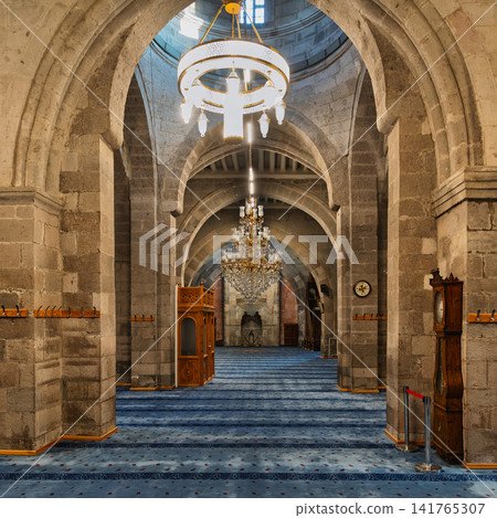 Ornate chandeliers and stone arches inside the historic Kayseri Grand Mosque or Ulu Camii in Kayseri, Turkey Ornate chandeliers and stone arches inside the historic Kayseri Grand Mosque or Ulu Camii in Kayseri, Turkey 141765307