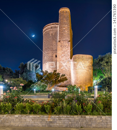 Maiden Tower illuminated at night with a crescent moon in the Old City of Baku, Azerbaijan 141765390
