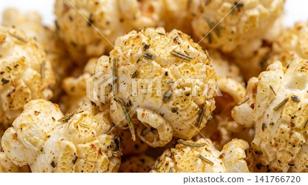 Gourmet savory herb seasoned popcorn close up macro shot with seasoned snacking aromatic appetizer culinary ingredient delicious infusion 141766720