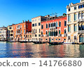 Traditional Venetian architecture lining the Grand Canal in Venice, Italy. Vibrant waterfront scene showcasing the beauty of this world-famous city. 141766880