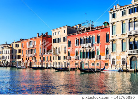 Traditional Venetian architecture lining the Grand Canal in Venice, Italy. Vibrant waterfront scene showcasing the beauty of this world-famous city. Traditional Venetian architecture lining the Grand Canal in Venice, Italy. Vibrant waterfront scene showcasing the beauty of this world-famous city. 141766880