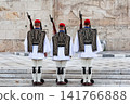 Traditional Evzones guards standing in ceremonial uniform in Athens, Greece. Iconic symbol of Greek history, heritage and national identity near the Hellenic Parliament. 141766888