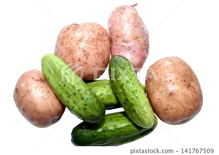 A selection of fresh vegetables such as potatoes and cucumbers. A selection of fresh vegetables such as potatoes and cucumbers. 141767509