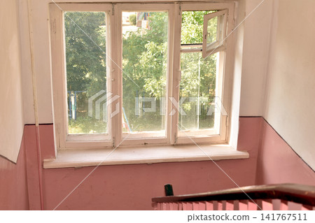 A window in the entrance of a multi-story building. A window in the entrance of a multi-story building. 141767511