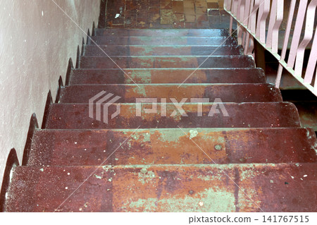 A flight of stairs with railings in an old multi-story building. A flight of stairs with railings in an old multi-story building. 141767515