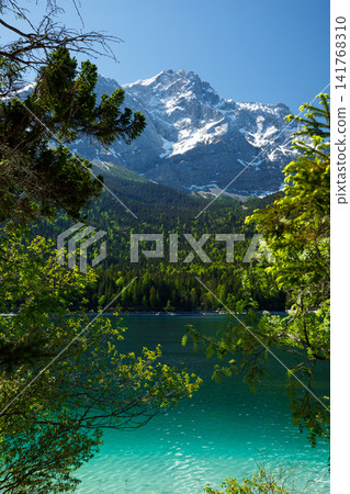 Travel landscape of Zugspitze Alps in Bavaria, Germany, scenic summer nature panorama with forest, Eibsee lake, snow mountains peak. Alpine landscape 141768310