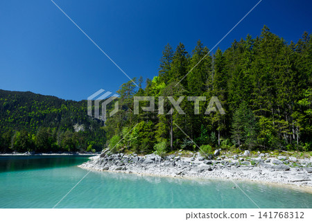 Travel landscape of Zugspitze Alps in Bavaria, Germany, scenic summer nature panorama with forest, Eibsee lake. Alpine landscape Travel landscape of Zugspitze Alps in Bavaria, Germany, scenic summer nature panorama with forest, Eibsee lake. Alpine landscape 141768312