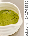 Close-up of freshly prepared matcha tea with smooth foam in a ceramic bowl. Traditional Japanese green tea ready to serve 141768530