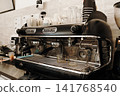 Commercial espresso machine ready for coffee preparation behind the bar. Professional cafe equipment used for brewing espresso and specialty coffee drinks 141768540