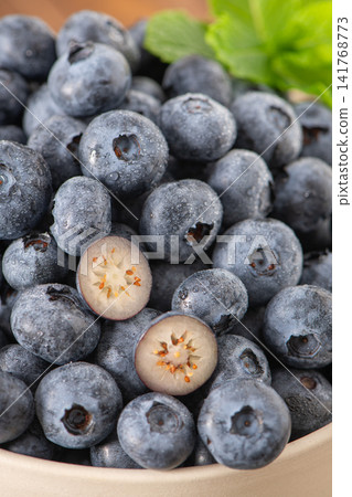 Fresh juicy blueberries with slice details macro Fresh juicy blueberries with slice details macro 141768773