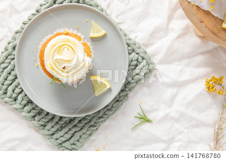 Lemon cupcake with white frosting from top view Lemon cupcake with white frosting from top view 141768780