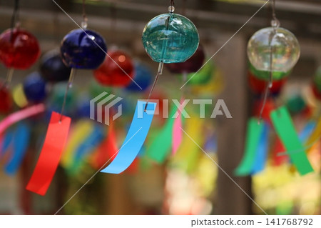 Wind chimes swaying in the wind Wind chimes swaying in the wind 141768792