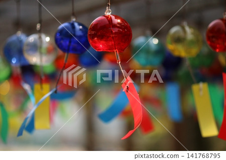 Wind chimes swaying in the wind Wind chimes swaying in the wind 141768795