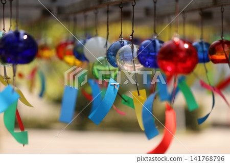 Wind chimes swaying in the wind Wind chimes swaying in the wind 141768796