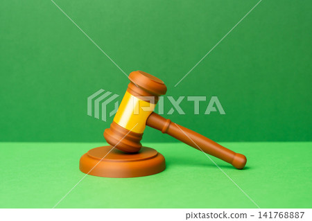 Gavel on a green background. A favorable verdict, a victory in court. Dispute resolution. Protection of rights and freedoms. Laws and regulations. Court decisions. Legal protection Gavel on a green background. A favorable verdict, a victory in court. Dispute resolution. Protection of rights and freedoms. Laws and regulations. Court decisions. Legal protection 141768887