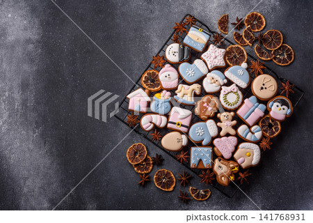 Gingerbread as a Christmas staple, sweet biscuits for the holiday. Gingerbread as a background Gingerbread as a Christmas staple, sweet biscuits for the holiday. Gingerbread as a background 141768931
