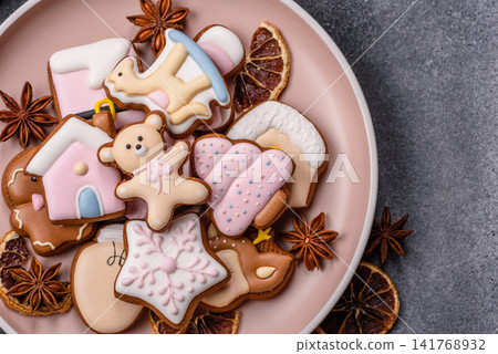 Gingerbread as a Christmas staple, sweet biscuits for the holiday. Gingerbread as a background Gingerbread as a Christmas staple, sweet biscuits for the holiday. Gingerbread as a background 141768932