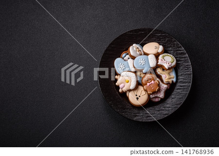 Gingerbread as a Christmas staple, sweet biscuits for the holiday. Gingerbread as a background Gingerbread as a Christmas staple, sweet biscuits for the holiday. Gingerbread as a background 141768936