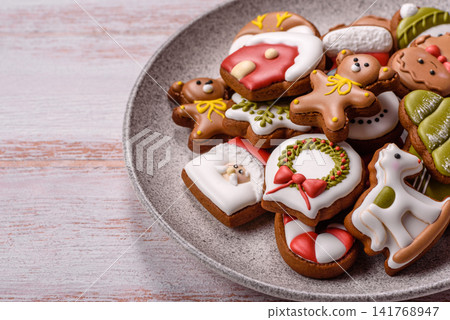 Gingerbread as a Christmas staple, sweet biscuits for the holiday. Gingerbread as a background Gingerbread as a Christmas staple, sweet biscuits for the holiday. Gingerbread as a background 141768947