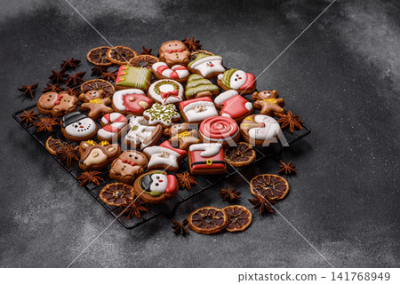 Gingerbread as a Christmas staple, sweet biscuits for the holiday. Gingerbread as a background Gingerbread as a Christmas staple, sweet biscuits for the holiday. Gingerbread as a background 141768949