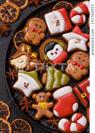 Gingerbread as a Christmas staple, sweet biscuits for the holiday. Gingerbread as a background Gingerbread as a Christmas staple, sweet biscuits for the holiday. Gingerbread as a background 141768953