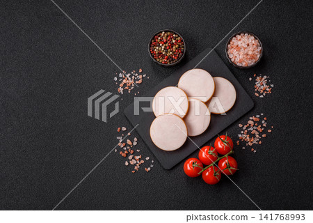 Slices of boiled chicken or pork sausage as an ingredient for home cooking. Sliced boiled sausage Slices of boiled chicken or pork sausage as an ingredient for home cooking. Sliced boiled sausage 141768993