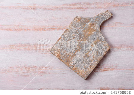 A square wooden cutting board for home food preparation. A wooden cutting board A square wooden cutting board for home food preparation. A wooden cutting board 141768998