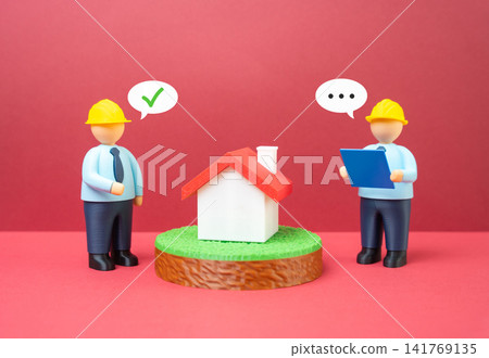 Engineers discussing a residential building project. Housing construction. Projects and design. Engineers discussing a residential building project. Housing construction. Projects and design. 141769135