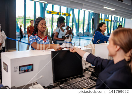 Traveler checking in airport with airline staff at counter 141769632