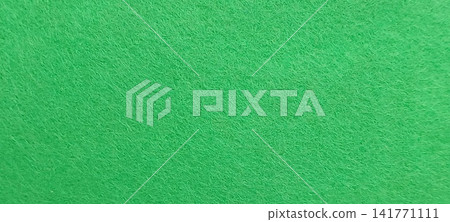 Vibrant green felt texture background with uniform fiber pattern Vibrant green felt texture background with uniform fiber pattern 141771111