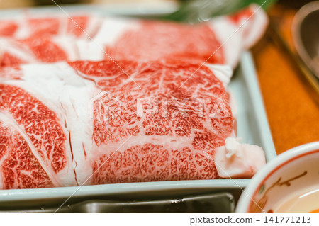 sliced Japanese wagyu beef in a ceramic plate prepared for Shabu Shabu 141771213