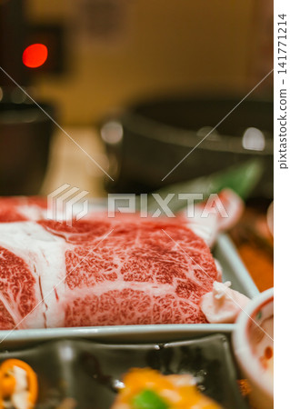 sliced Japanese wagyu beef in a ceramic plate prepared for Shabu Shabu sliced Japanese wagyu beef in a ceramic plate prepared for Shabu Shabu 141771214