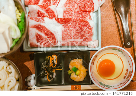 sliced Japanese wagyu beef in a ceramic plate prepared for Shabu Shabu sliced Japanese wagyu beef in a ceramic plate prepared for Shabu Shabu 141771215