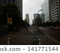 People walking on a rainy city sidewalk 141771544