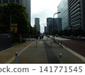 people walking on city sidewalk 141771545