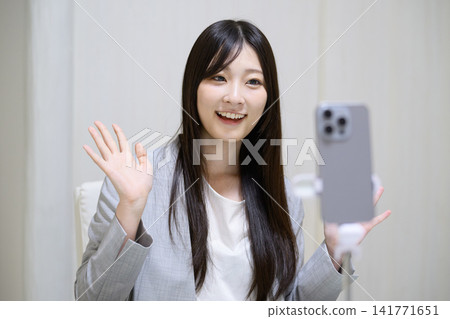 Japanese woman live streaming on her smartphone Japanese woman live streaming on her smartphone 141771651