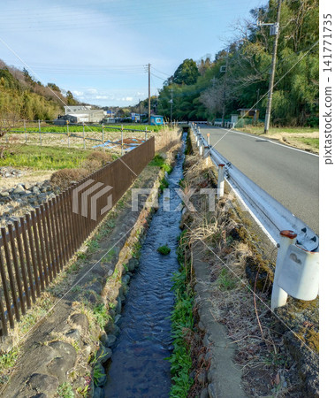 A peaceful rural landscape of Machida City, Tokyo, with agricultural irrigation canals flowing through it. A peaceful rural landscape of Machida City, Tokyo, with agricultural irrigation canals flowing through it. 141771735