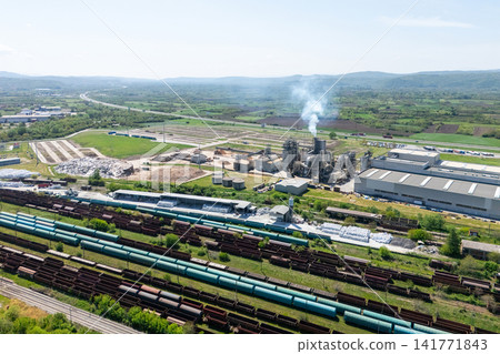 Aerial shot of a manufacturing facility with smoking chimney during production 141771843