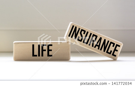 Life insurance the words written on wooden blocks against a light background Life insurance the words written on wooden blocks against a light background 141772034