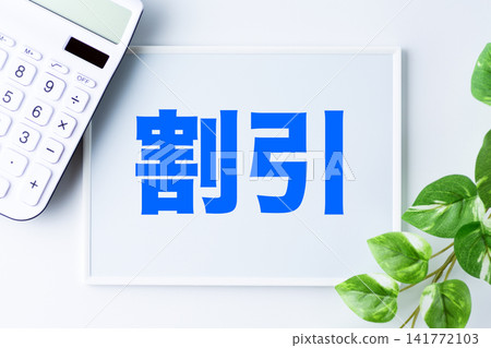 A whiteboard with the word "discount" and a white calculator A whiteboard with the word "discount" and a white calculator 141772103