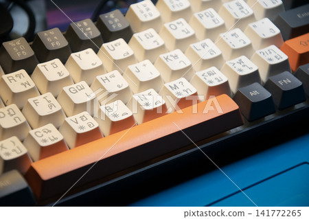 A side view of the keyboard placed on the desk. A side view of the keyboard placed on the desk. 141772265