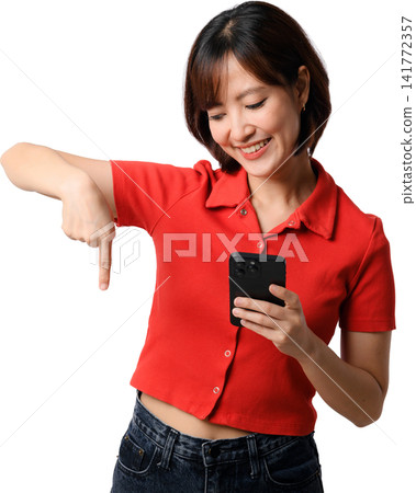 Asian woman smartphone red shirt pointing isolated portrait, smiling while checking mobile phone against transparent background Asian woman smartphone red shirt pointing isolated portrait, smiling while checking mobile phone against transparent background 141772357