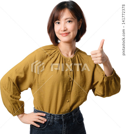 Asian woman thumbs up isolated portrait mustard blouse positive gesture confident smile with hand on waist against transparent background Asian woman thumbs up isolated portrait mustard blouse positive gesture confident smile with hand on waist against transparent background 141772378