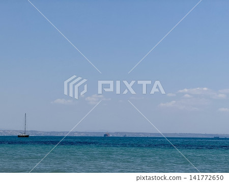 Ships and yachts sail near the coast and beaches. 141772650