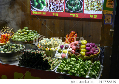 Stalls with national Chinese takeaway food in a night city in Zhangjajie, China Stalls with national Chinese takeaway food in a night city in Zhangjajie, China 141772819